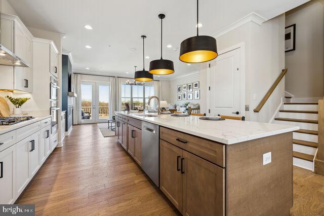 14917 Dispatch Street Rockville, MD 20850 - Photo 15 of 29 a large kitchen with stainless steel appliances kitchen island granite countertop a sink a counter space and a view of living room