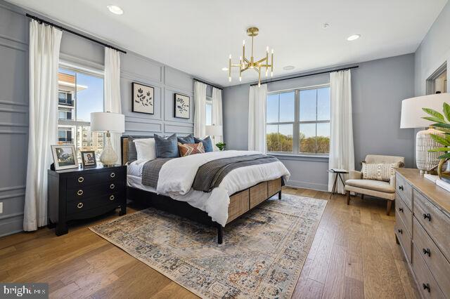 14917 Dispatch Street Rockville, MD 20850 - Photo 19 of 29 a bedroom with a bed and a chandelier