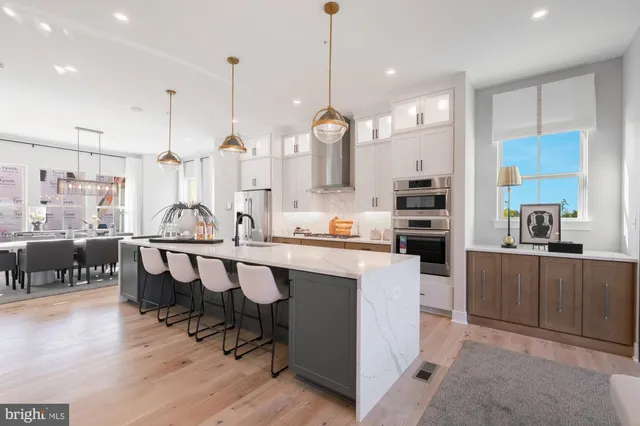 a large kitchen with lots of counter space and furniture
