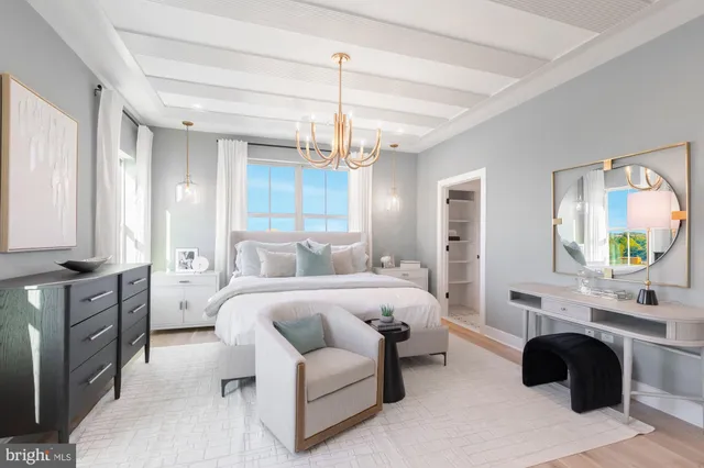 a spacious bedroom with a bed a couch and dresser