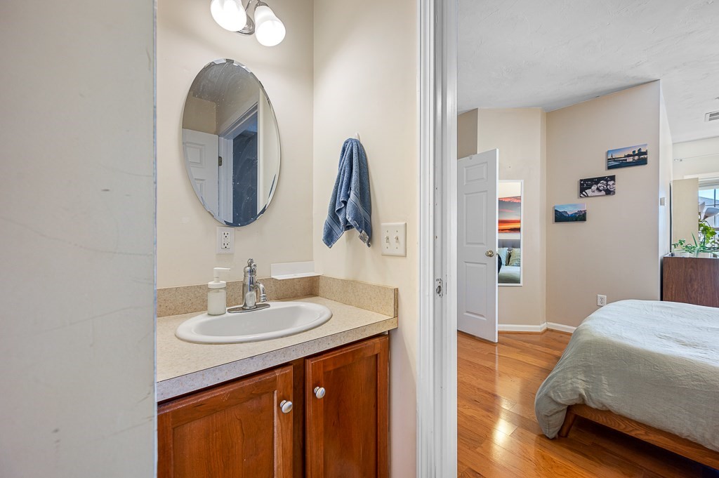 50 Adams Street, Unit 101 Worcester, MA 01604 - Photo 14 of 20 a en suite bathroom with a sink and a mirror
