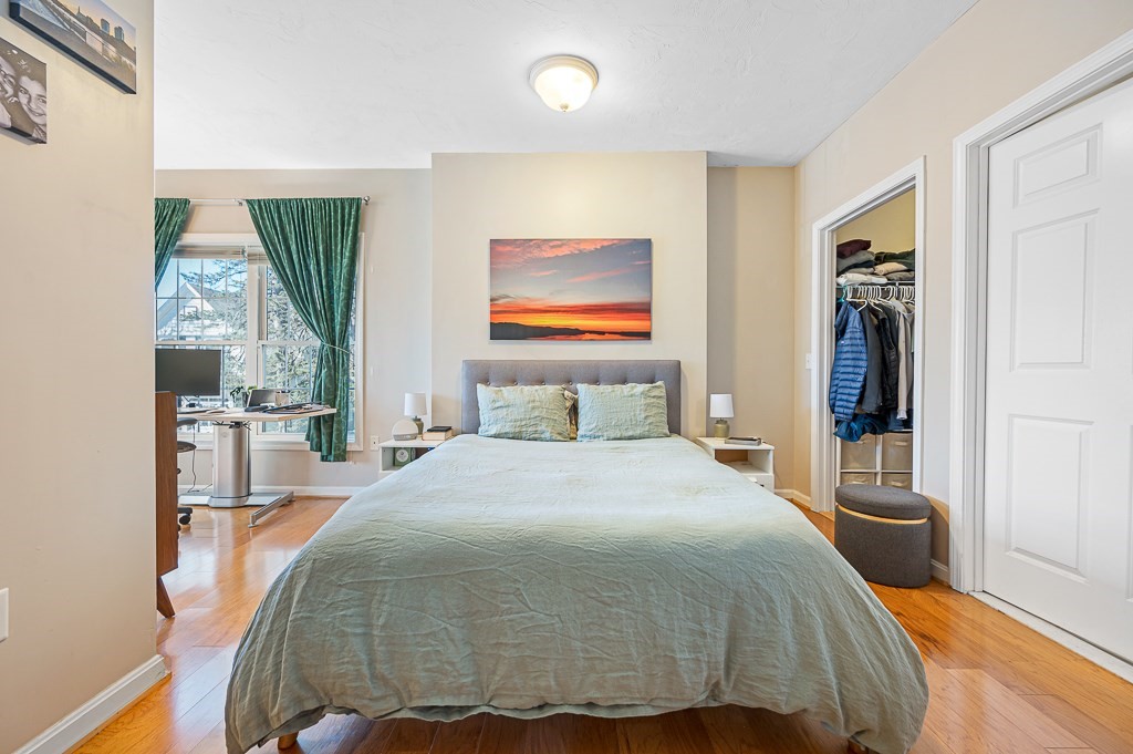 50 Adams Street, Unit 101 Worcester, MA 01604 - Photo 10 of 20 a bedroom with a bed and glass window