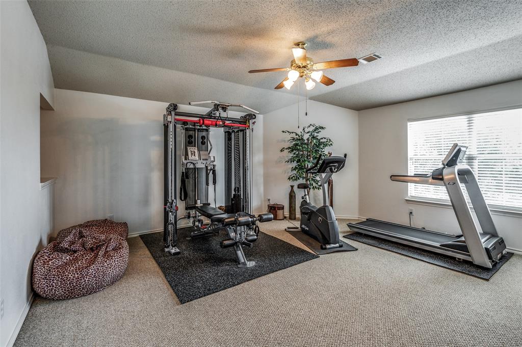 8606 Scooner Street Rowlett, TX 75089 - Photo 18 of 30 a view of a room with gym equipment
