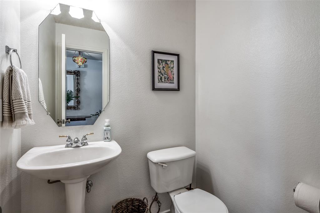 8606 Scooner Street Rowlett, TX 75089 - Photo 23 of 30 a bathroom with a toilet sink and mirror