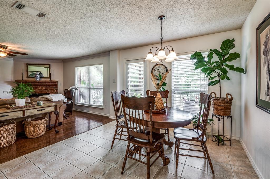 8606 Scooner Street Rowlett, TX 75089 - Photo 8 of 30 a view of a dining room with furniture window and wooden floor