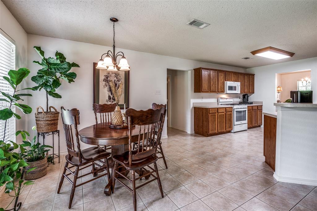 8606 Scooner Street Rowlett, TX 75089 - Photo 9 of 30 a view of a dining room with furniture window and wooden floor