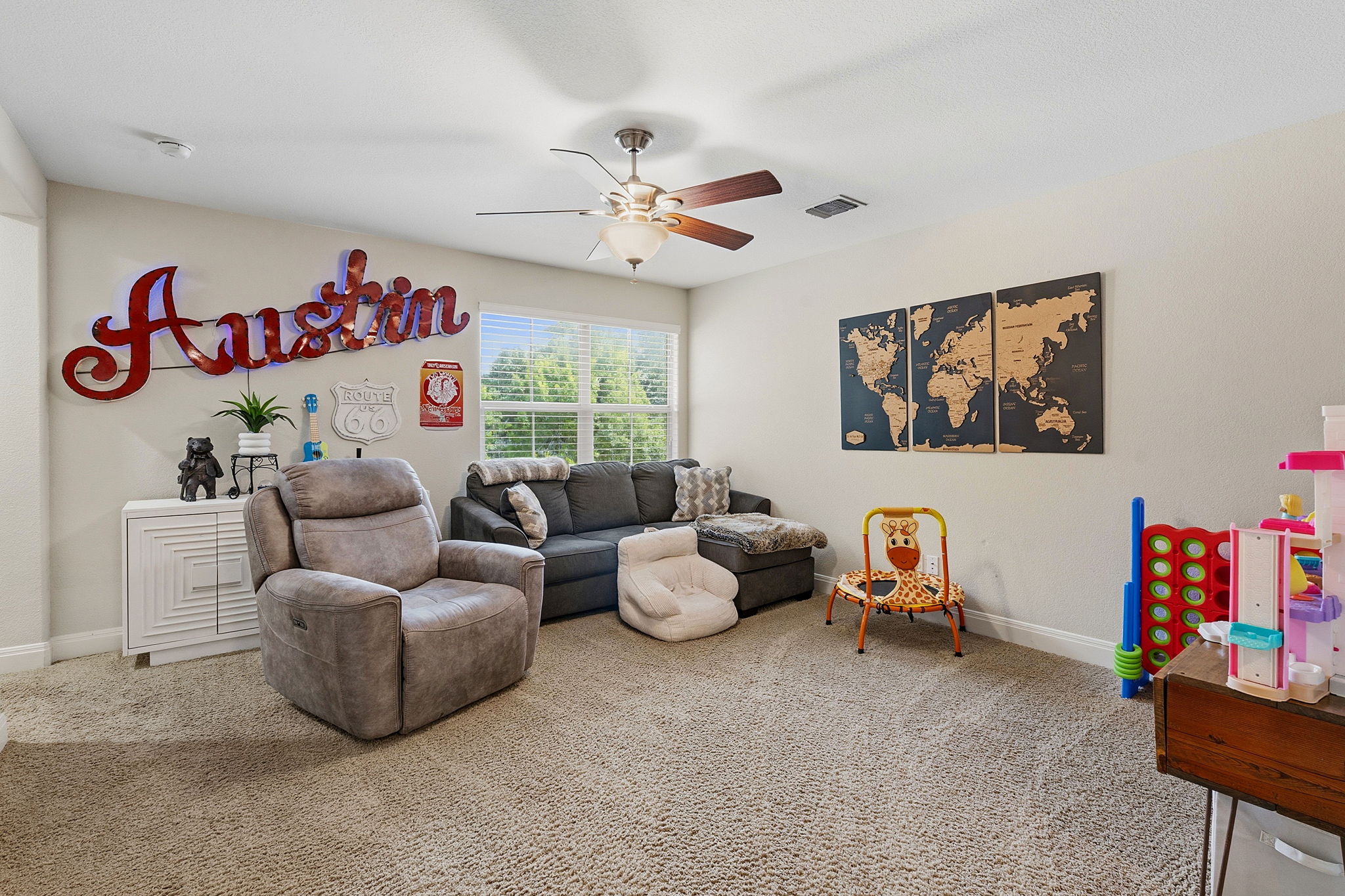 15317 Falconhead Grove Loop Austin, TX 78738 - Photo 13 of 36 Carpeted room featuring a ceiling fan with integrated lighting, a large window with blinds, and white baseboards