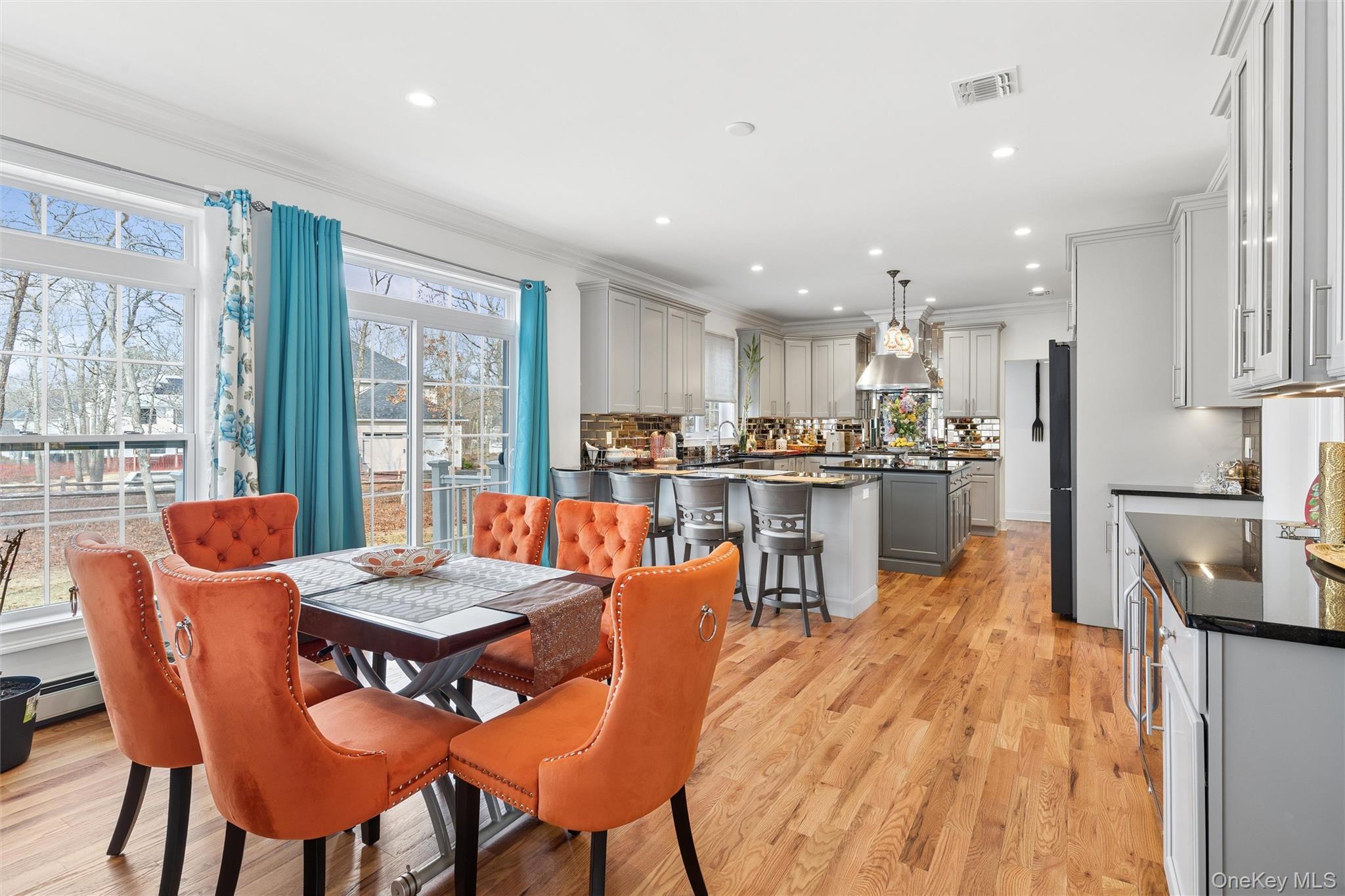 16 Gateway Court Hampton Bays, NY 11946 - Photo 11 of 30 a dining room filled counter top space a large window and stainless steel appliances