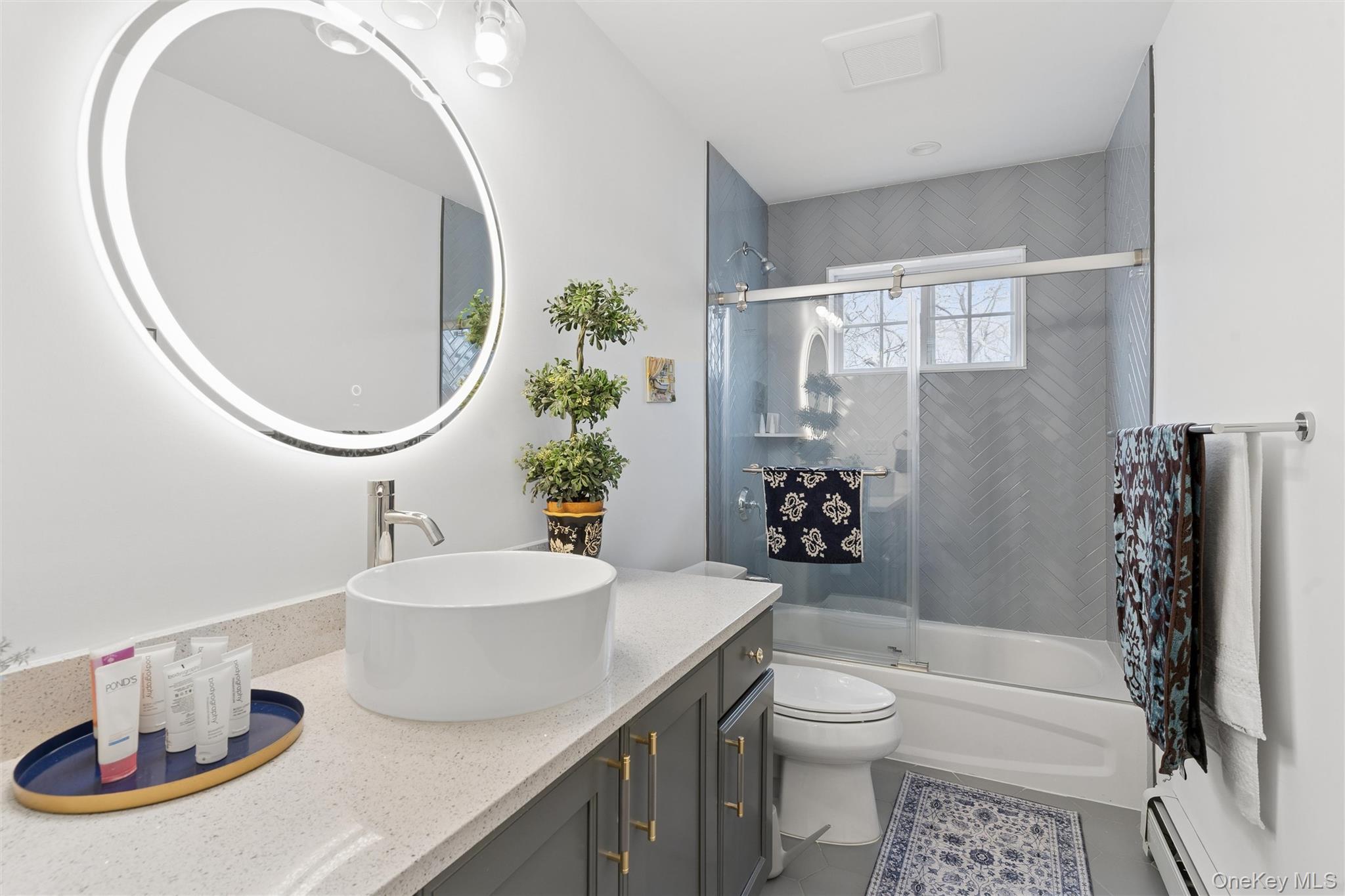 16 Gateway Court Hampton Bays, NY 11946 - Photo 14 of 30 a bathroom with a sink a toilet and shower