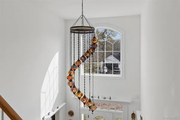 a view of staircase with white walls and a window