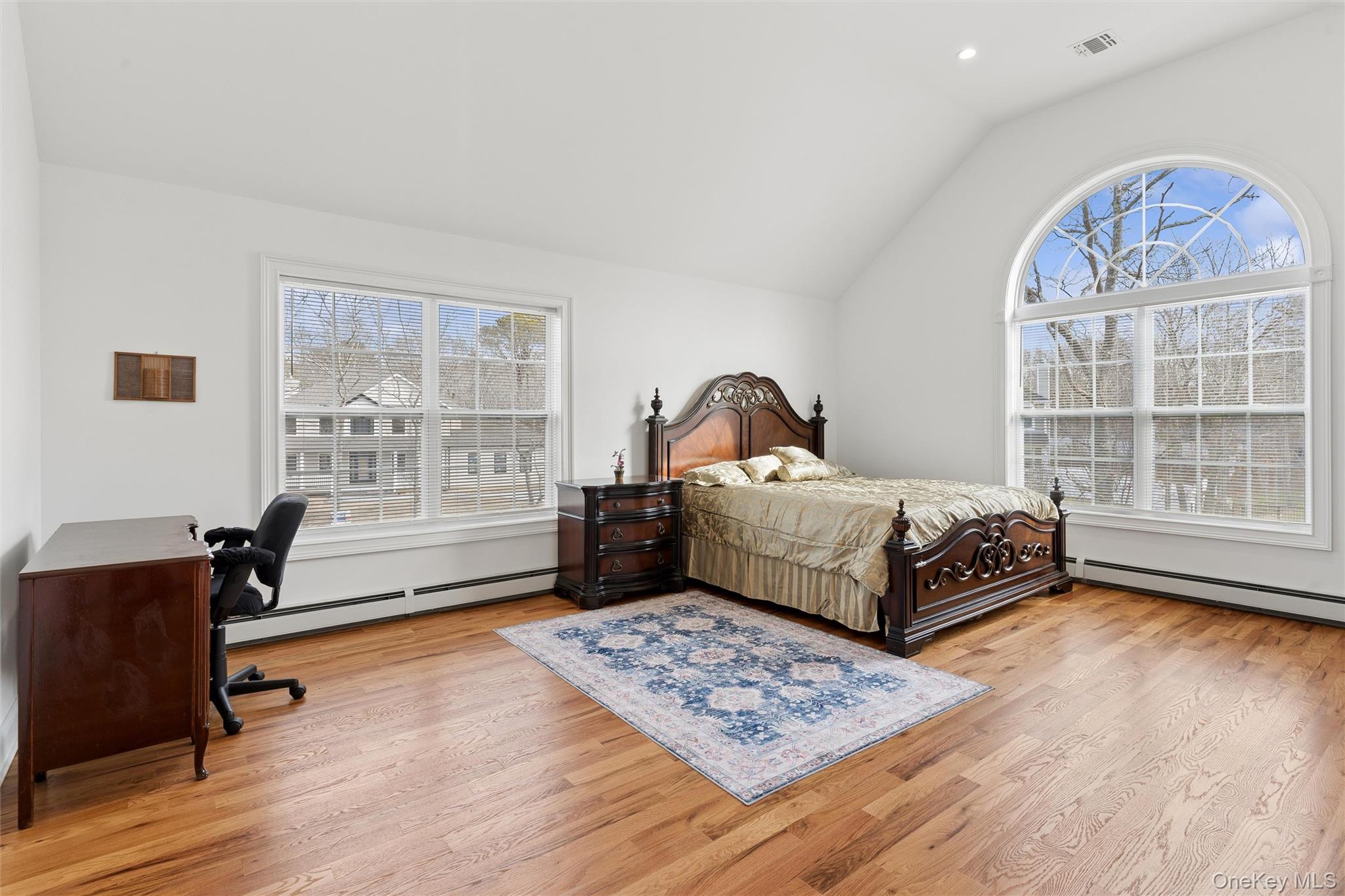 16 Gateway Court Hampton Bays, NY 11946 - Photo 17 of 30 a bedroom with a bed and wooden floor