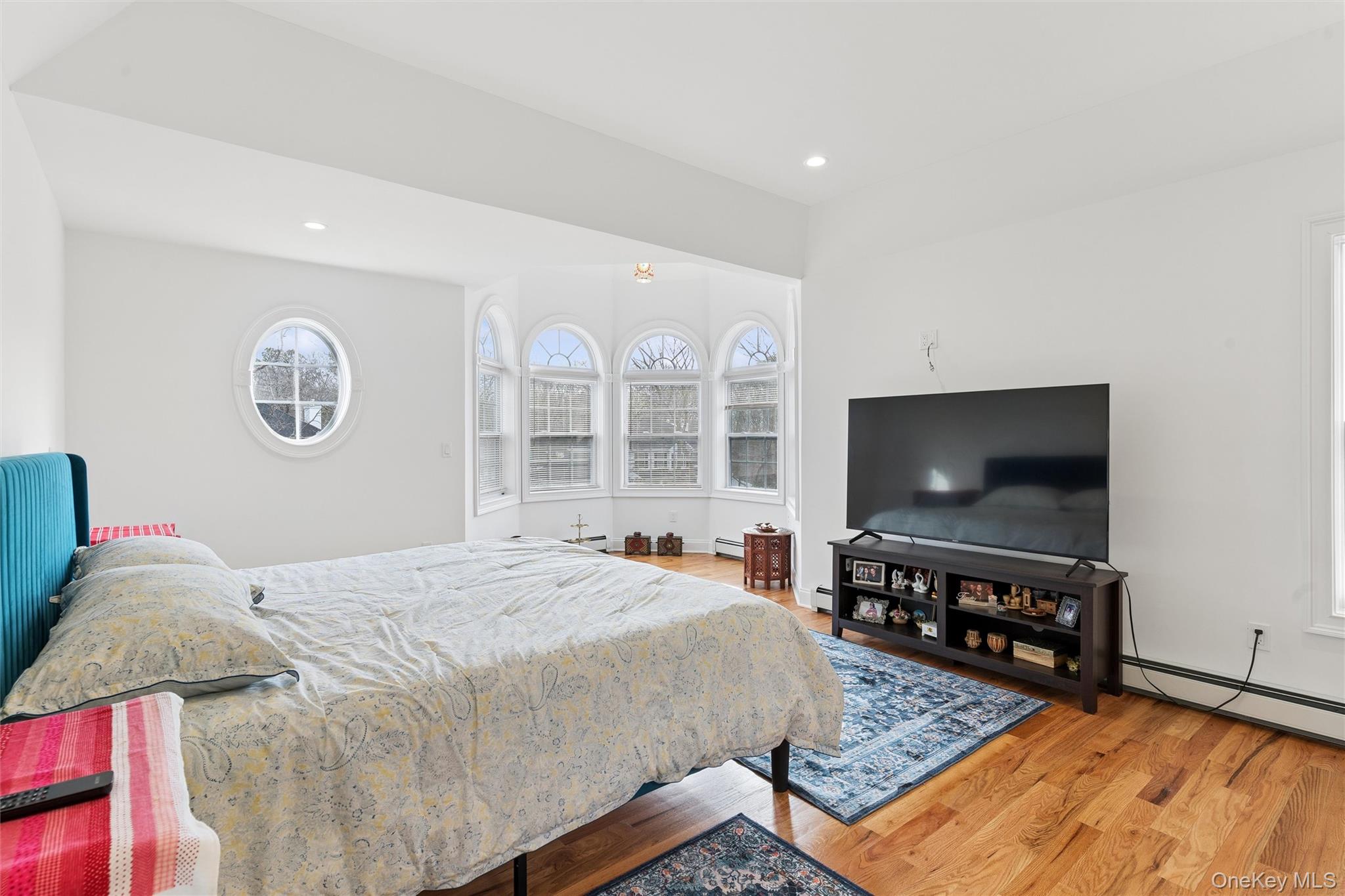 16 Gateway Court Hampton Bays, NY 11946 - Photo 20 of 30 a bedroom with a bed and a flat screen tv