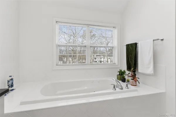 a white bath tub sitting next to a window
