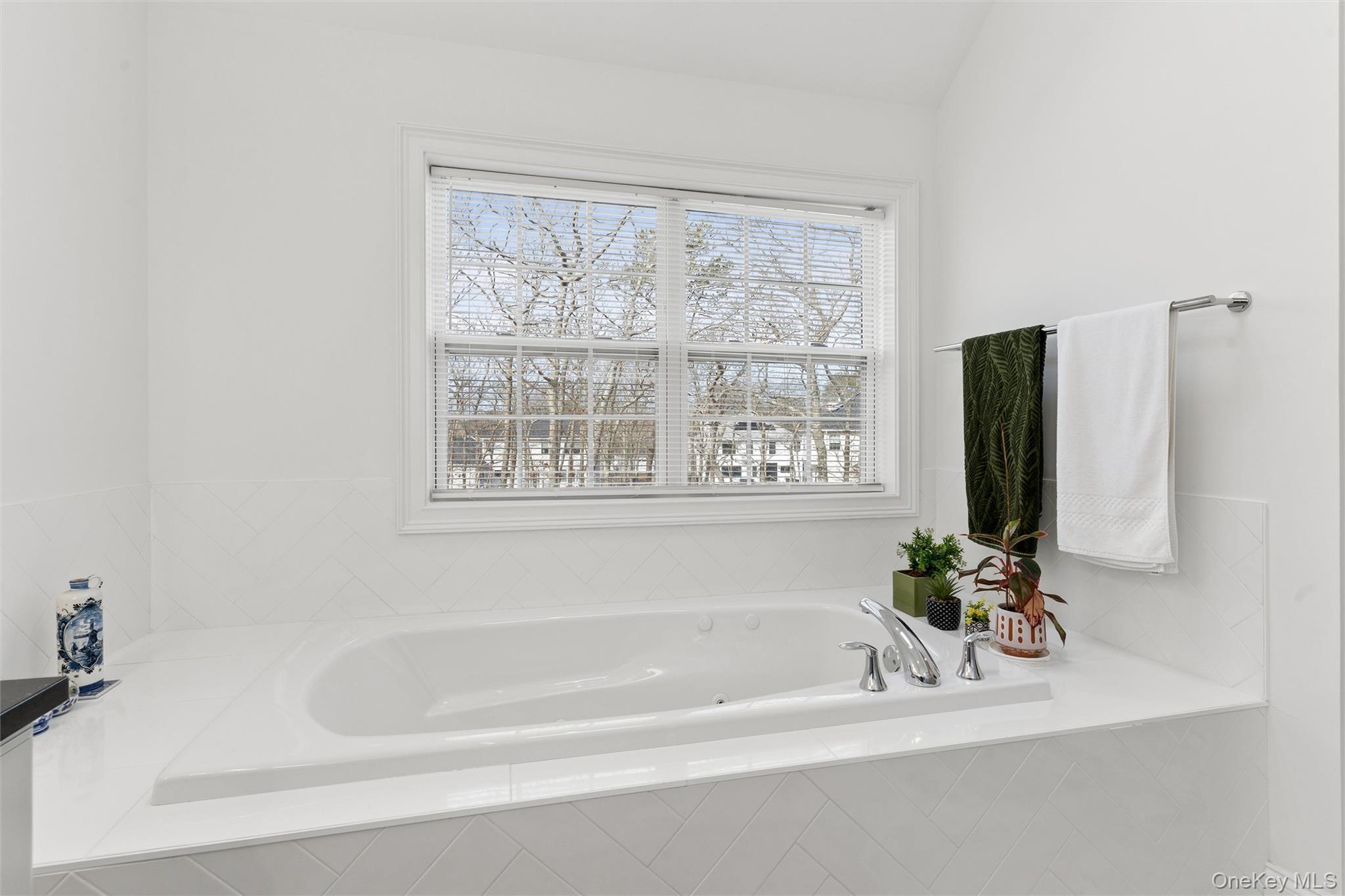 16 Gateway Court Hampton Bays, NY 11946 - Photo 24 of 30 a white bath tub sitting next to a window