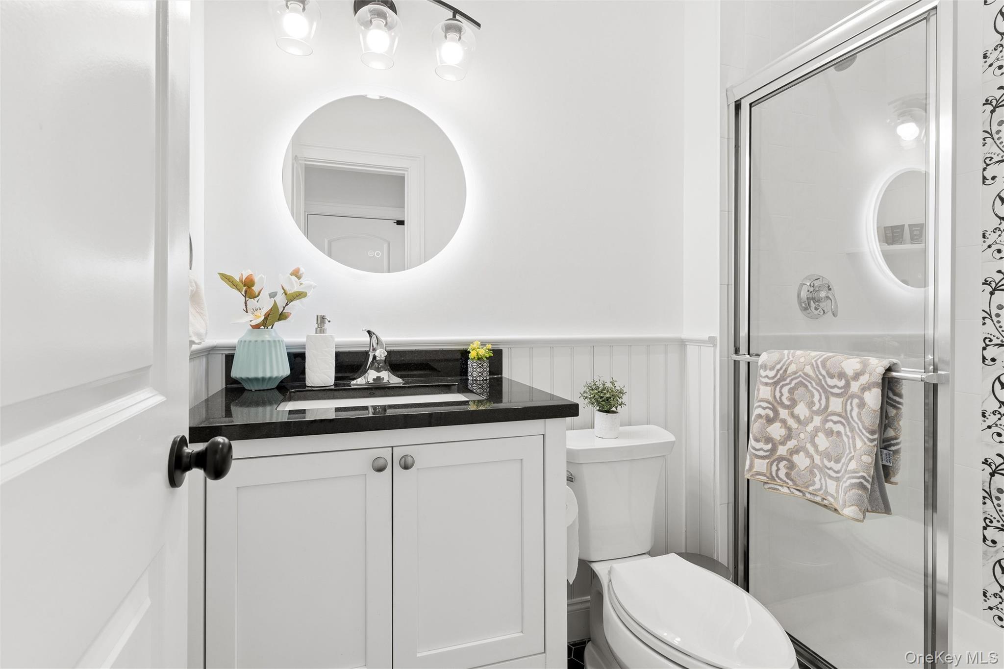 16 Gateway Court Hampton Bays, NY 11946 - Photo 25 of 30 a bathroom with a toilet a sink and mirror