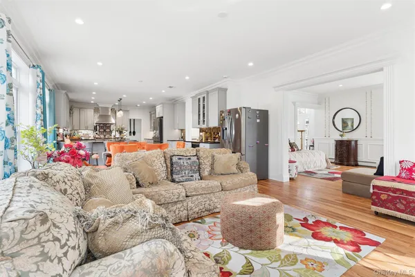 a living room with furniture and kitchen view