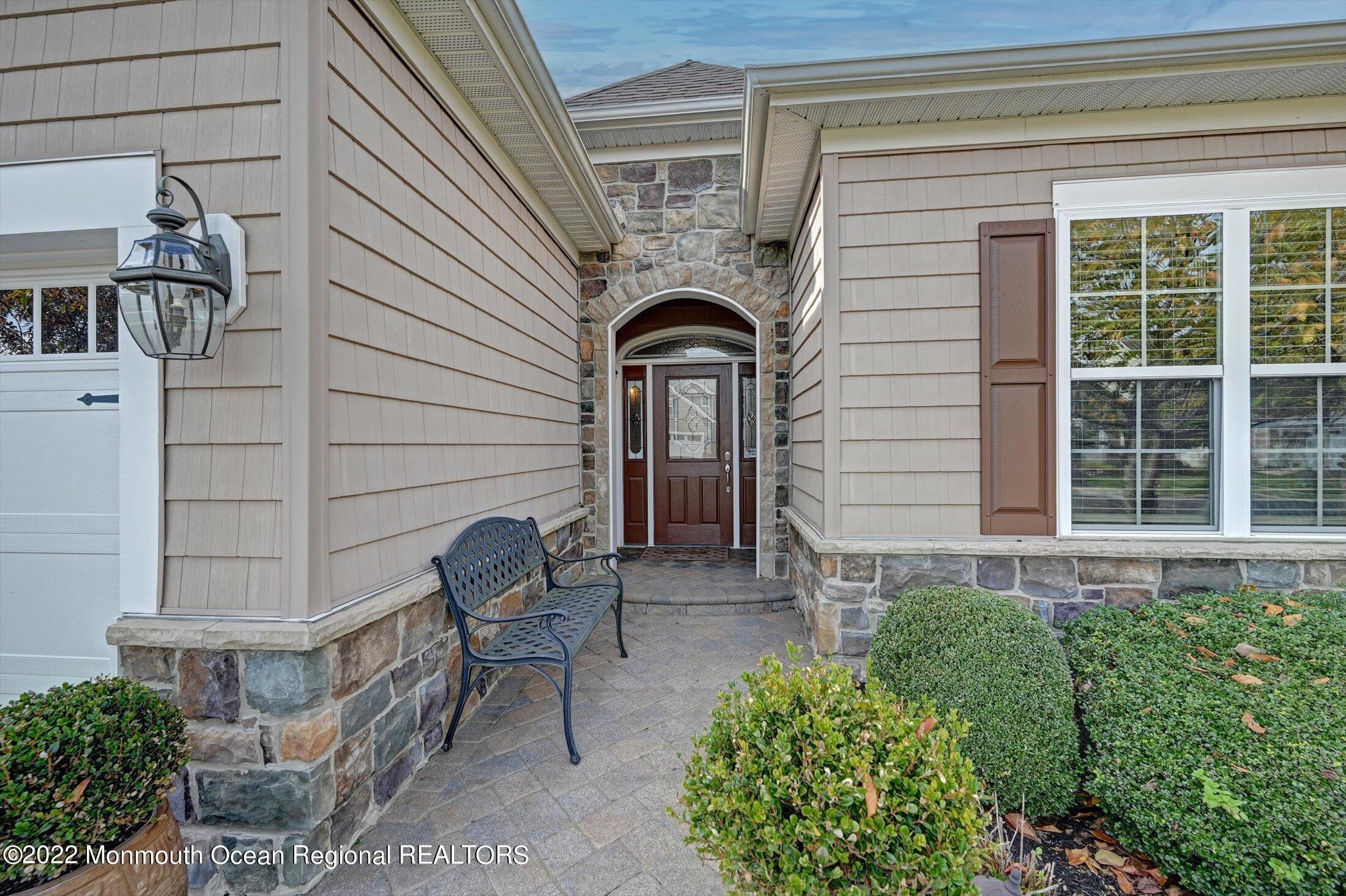 20 East Francesa Court Farmingdale, NJ 07727 - Photo 3 of 78 a front view of a house with outdoor seating and plants