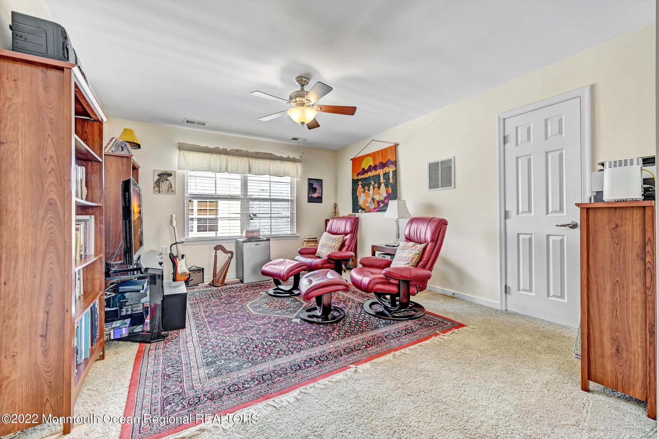 20 East Francesa Court Farmingdale, NJ 07727 - Photo 32 of 78 a living room with furniture windows and a flat screen tv