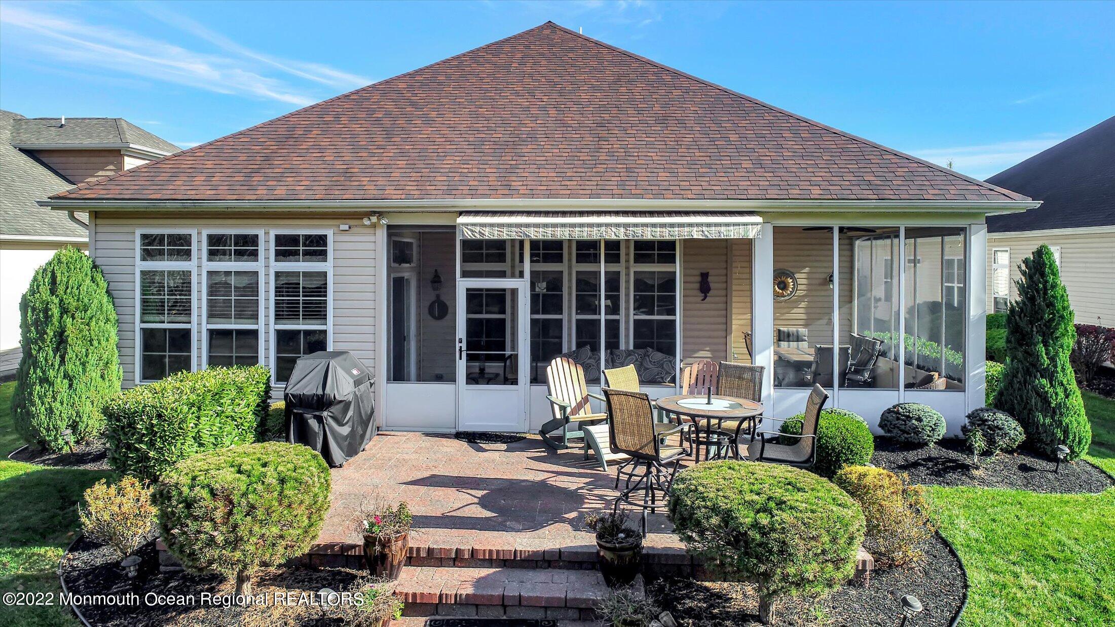 20 East Francesa Court Farmingdale, NJ 07727 - Photo 43 of 78 a front view of a house with garden and porch