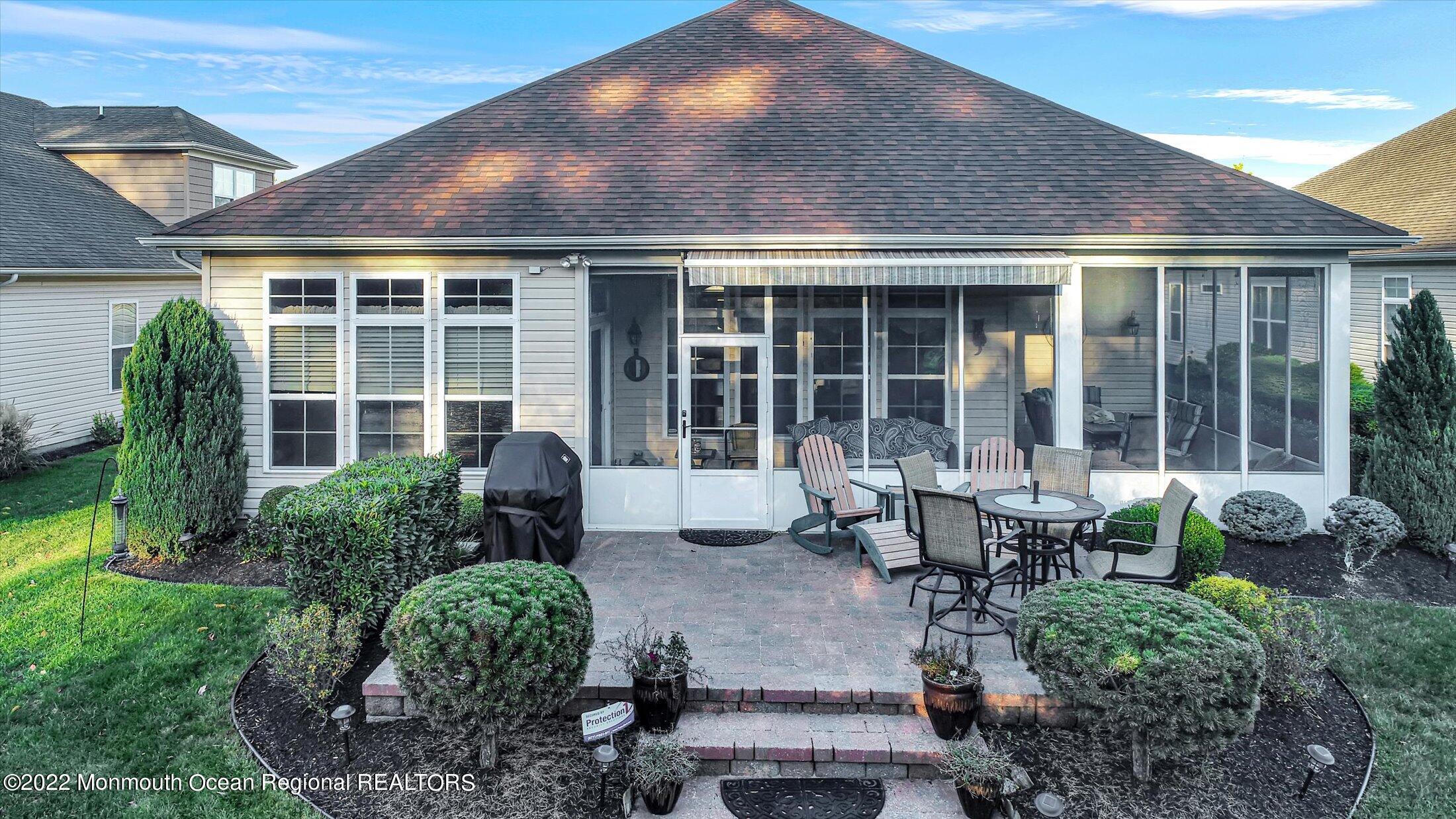 20 East Francesa Court Farmingdale, NJ 07727 - Photo 45 of 78 a house view with a seating space and garden