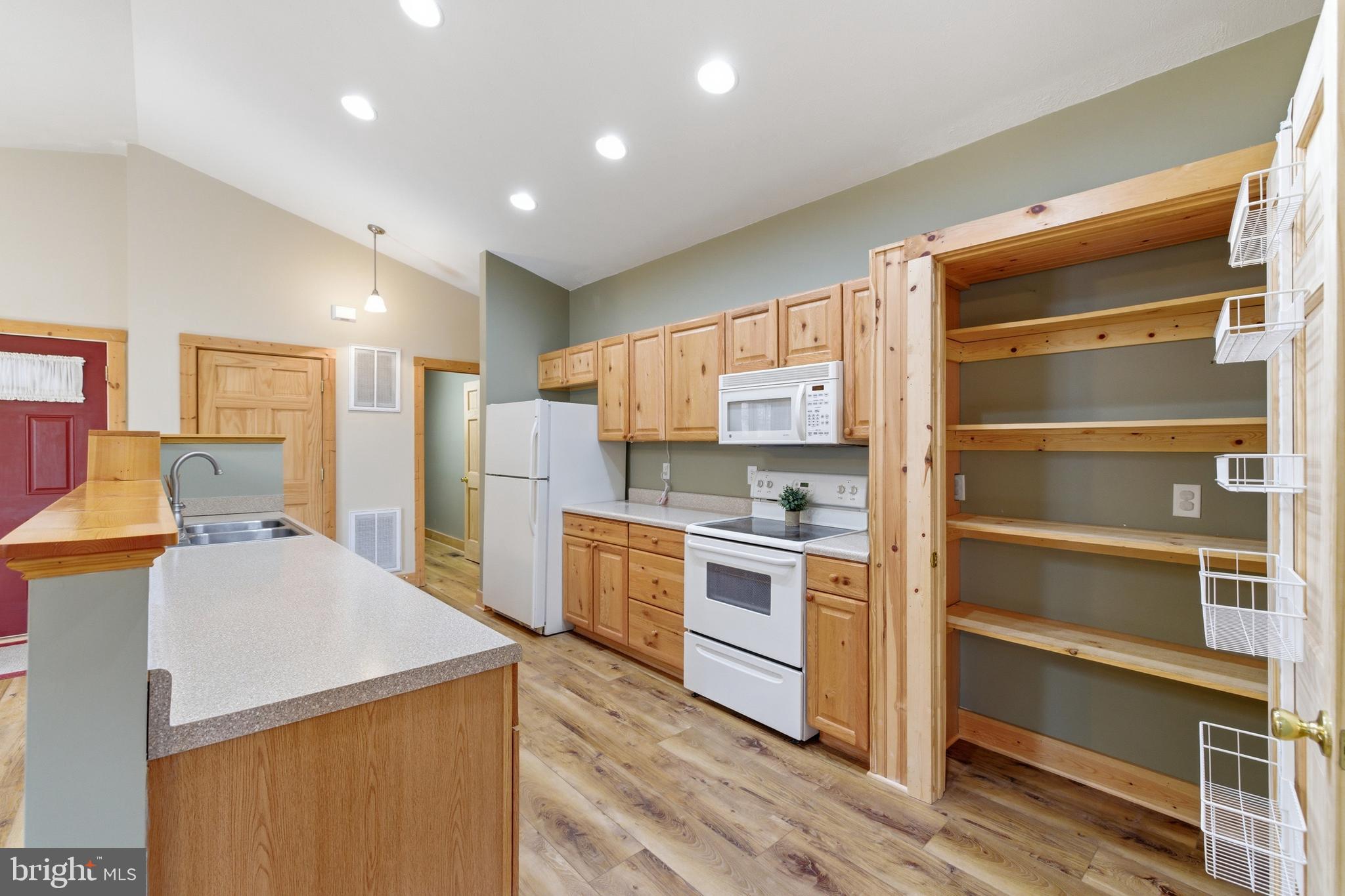 86 Maple Avenue Mount Jackson, VA 22842 - Photo 5 of 49 a kitchen with a refrigerator a stove top oven a sink and cabinets