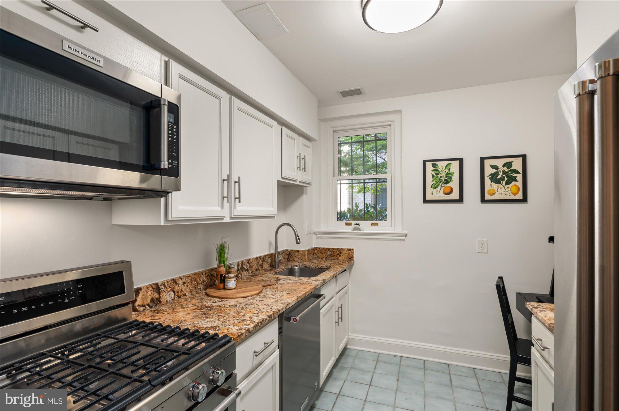 2101 Connecticut Avenue Northwest, Unit A Washington, DC 20009 - Photo 5 of 34 a kitchen with a stove and a microwave