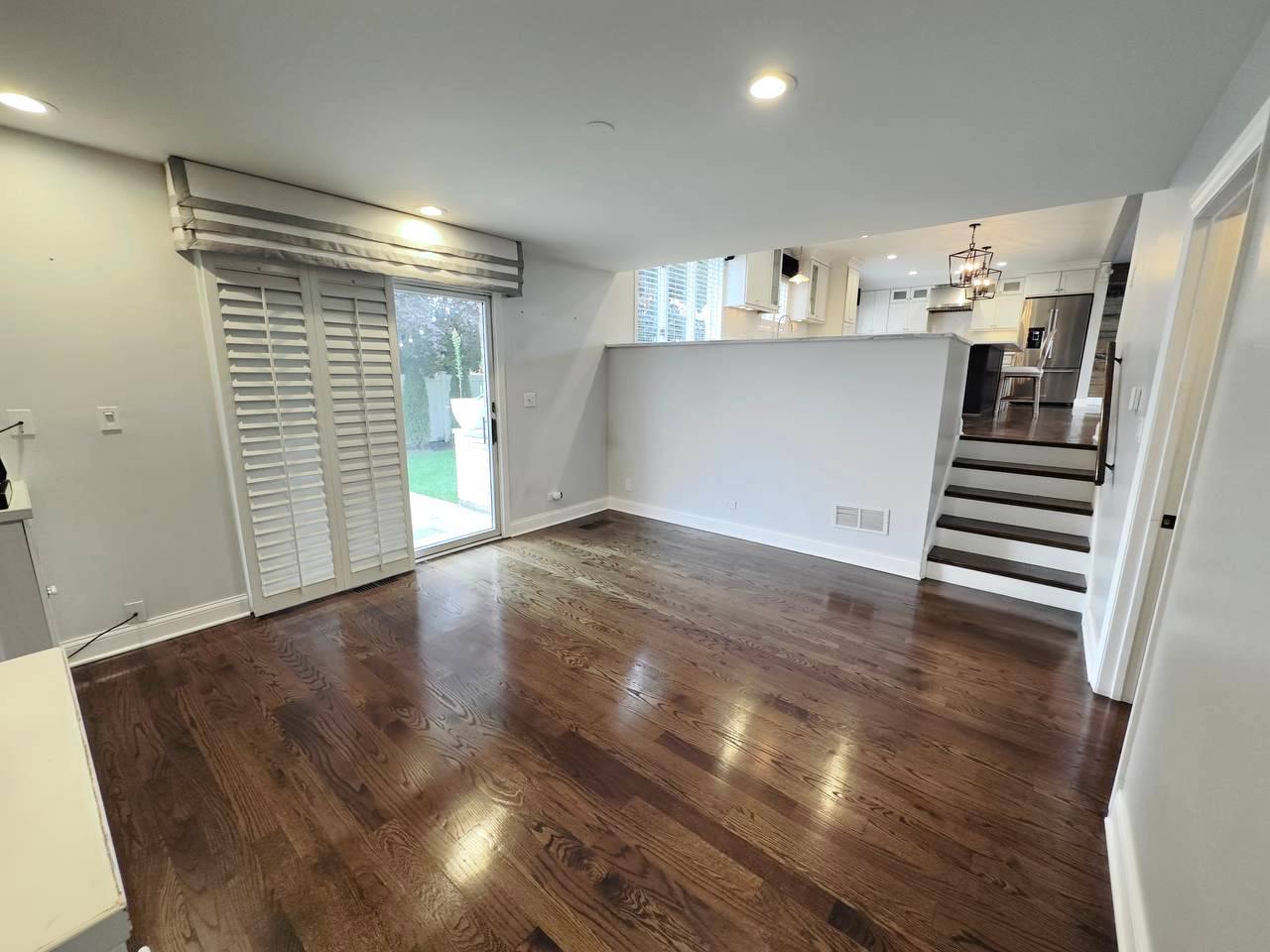 6140 Ruby Street Rosemont, IL 60018 - Photo 10 of 35 a view of a livingroom with wooden floor and stairs