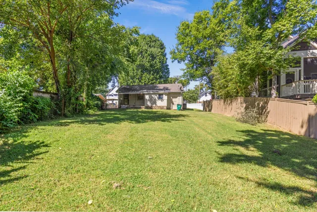 a view of a house with pool and sitting area