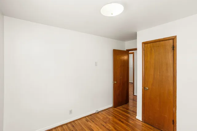 a view of hallway with wooden floor