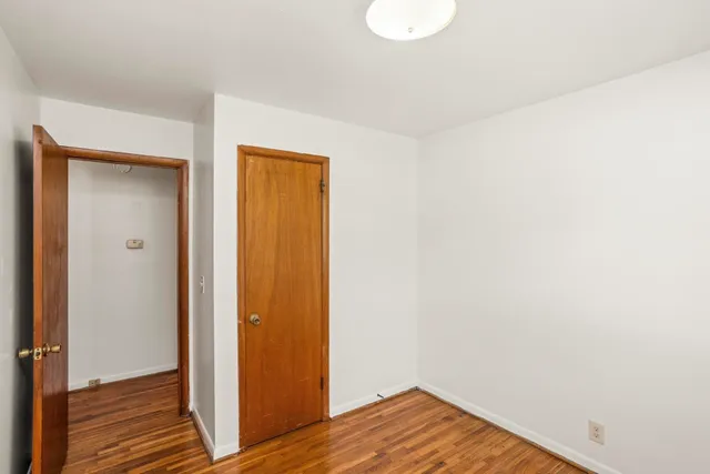 a view of a room with wooden floor