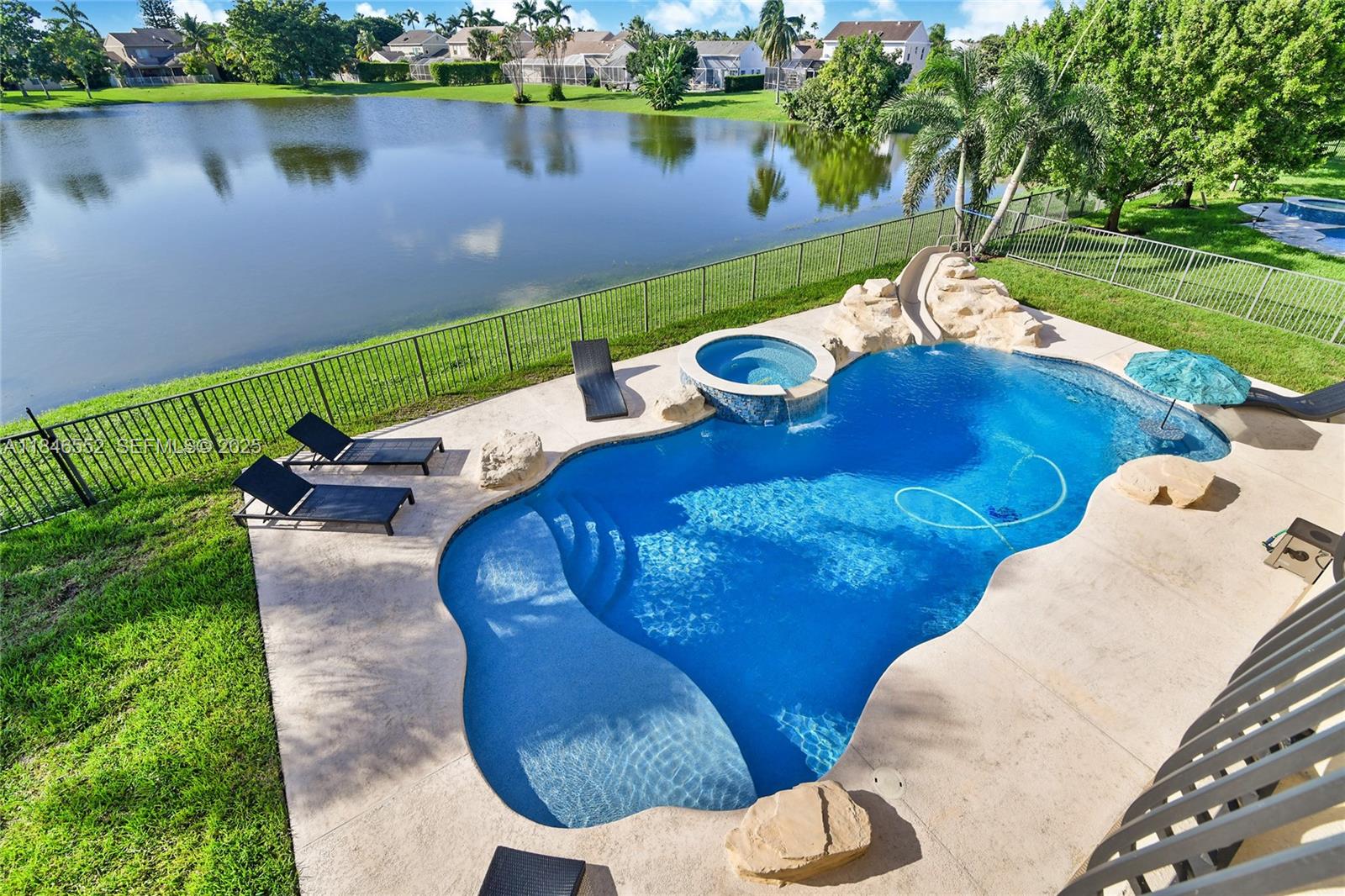 12137 Boca Reserve Lane Boca Raton, FL 33428 - Photo 14 of 35 a view of a backyard with table and chairs potted plants and lake view