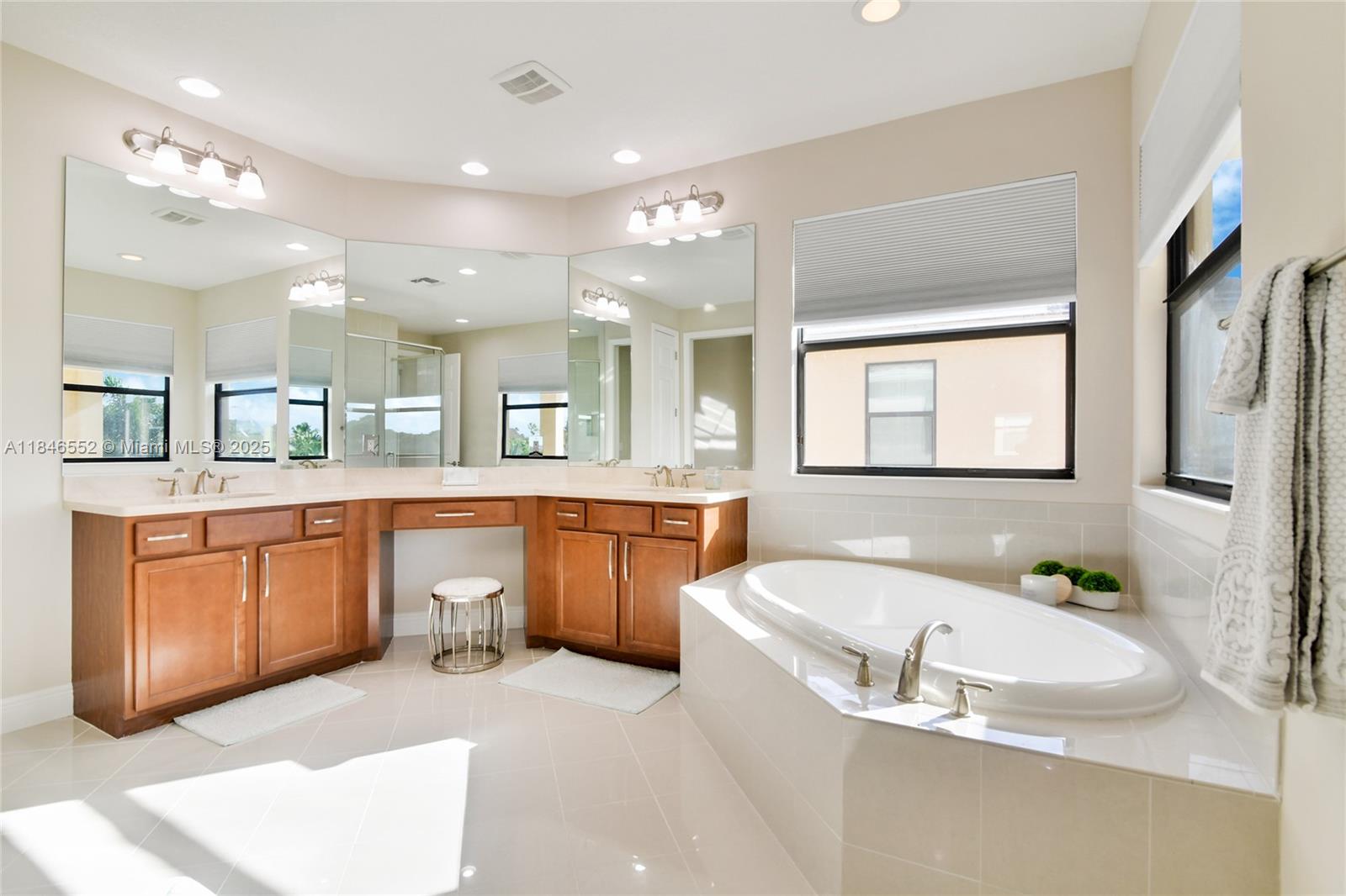 12137 Boca Reserve Lane Boca Raton, FL 33428 - Photo 17 of 35 a large bathroom with a tub a sink double vanity and a mirror