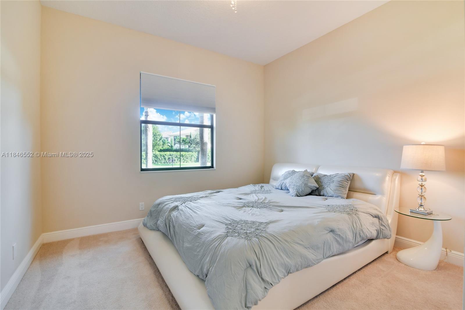 12137 Boca Reserve Lane Boca Raton, FL 33428 - Photo 26 of 35 a bedroom with a bed and a lamp