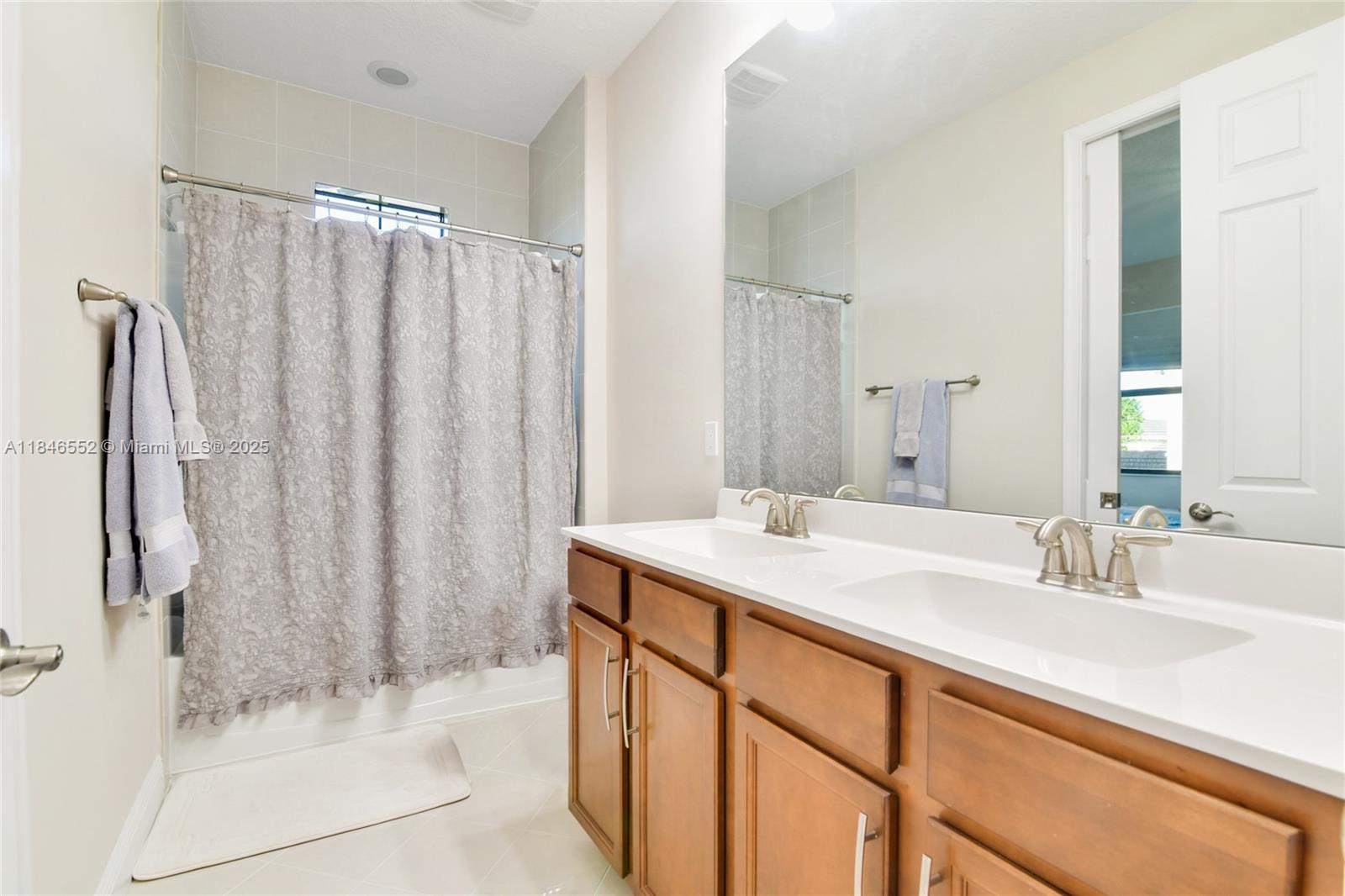 12137 Boca Reserve Lane Boca Raton, FL 33428 - Photo 29 of 35 a bathroom with a sink and a mirror
