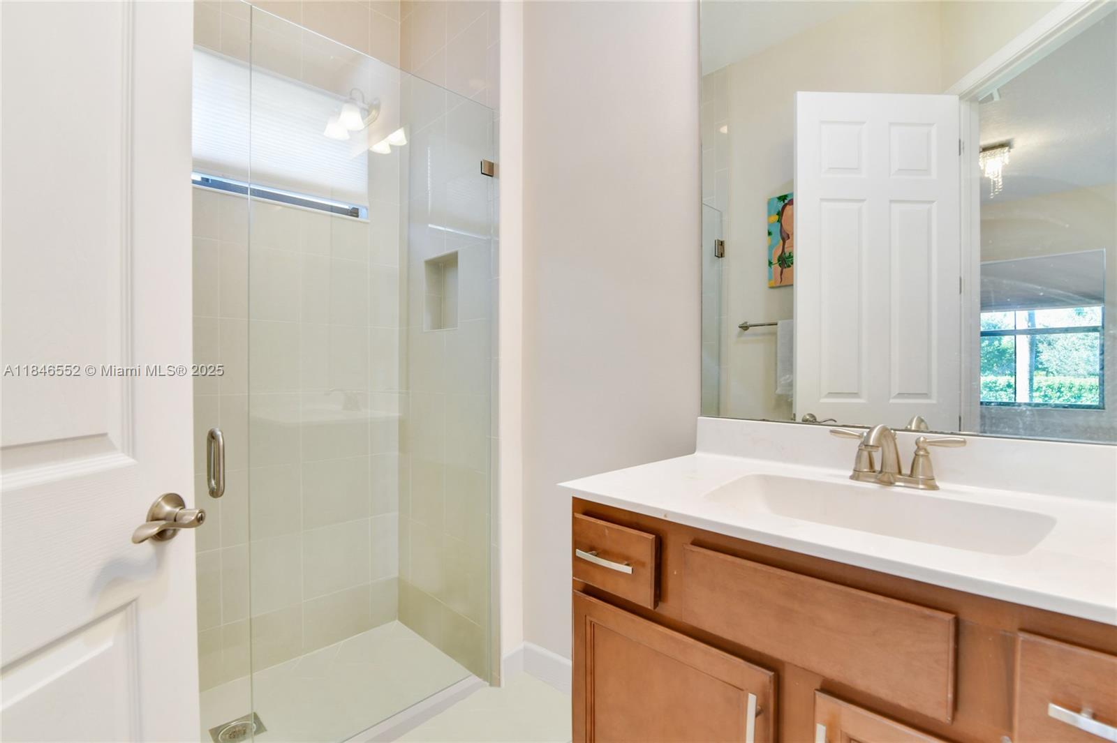 12137 Boca Reserve Lane Boca Raton, FL 33428 - Photo 31 of 35 a bathroom with a sink and a mirror