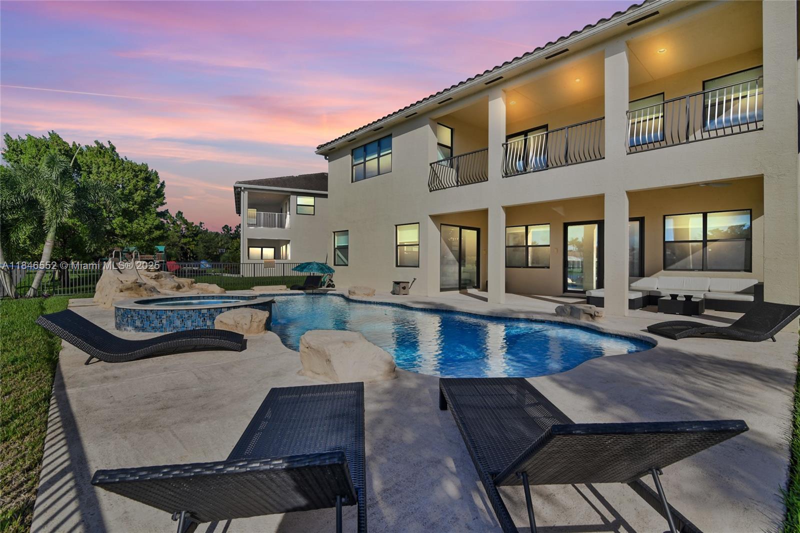 12137 Boca Reserve Lane Boca Raton, FL 33428 - Photo 35 of 35 a view of a patio with couches table and chairs with wooden floor and fence