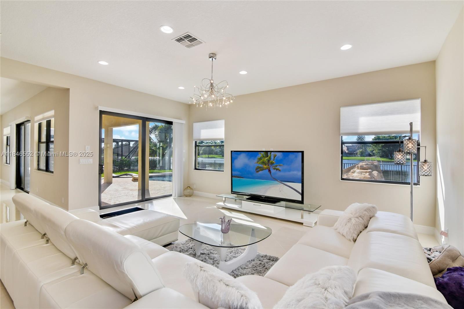 12137 Boca Reserve Lane Boca Raton, FL 33428 - Photo 4 of 35 a living room with furniture and a flat screen tv