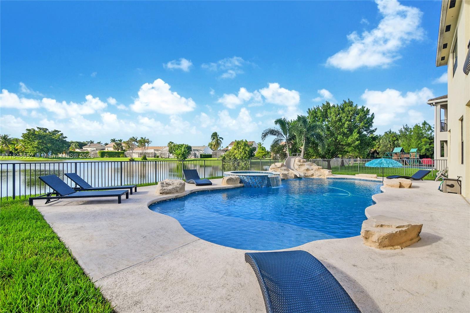 12137 Boca Reserve Lane Boca Raton, FL 33428 - Photo 7 of 35 a view of a swimming pool with a lounge chair