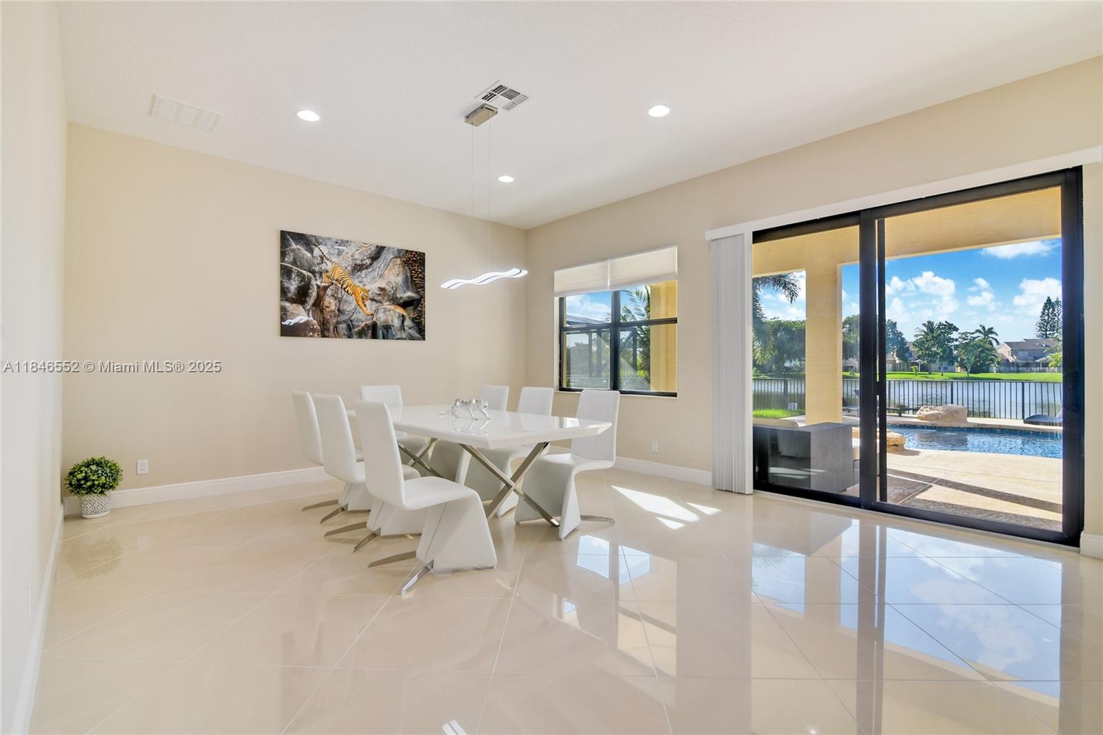 12137 Boca Reserve Lane Boca Raton, FL 33428 - Photo 9 of 35 a living room with furniture a large window and a flat screen tv