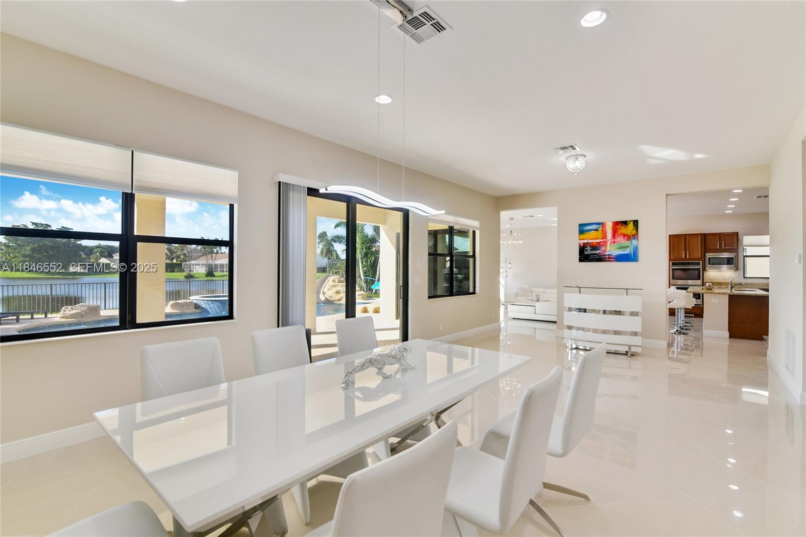 12137 Boca Reserve Lane Boca Raton, FL 33428 - Photo 10 of 35 a living room with stainless steel appliances furniture a flat screen tv and a kitchen view