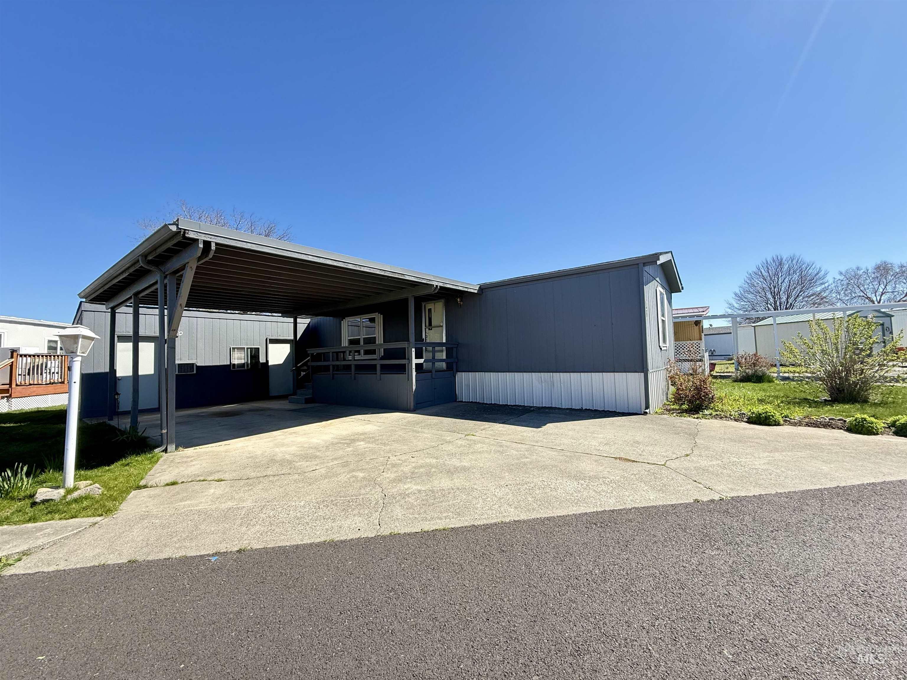 2015 6th Avenue, Unit 321 Clarkston, WA 99403 - Photo 4 of 34 Manufactured / mobile home featuring a deck, concrete driveway, and an attached carport