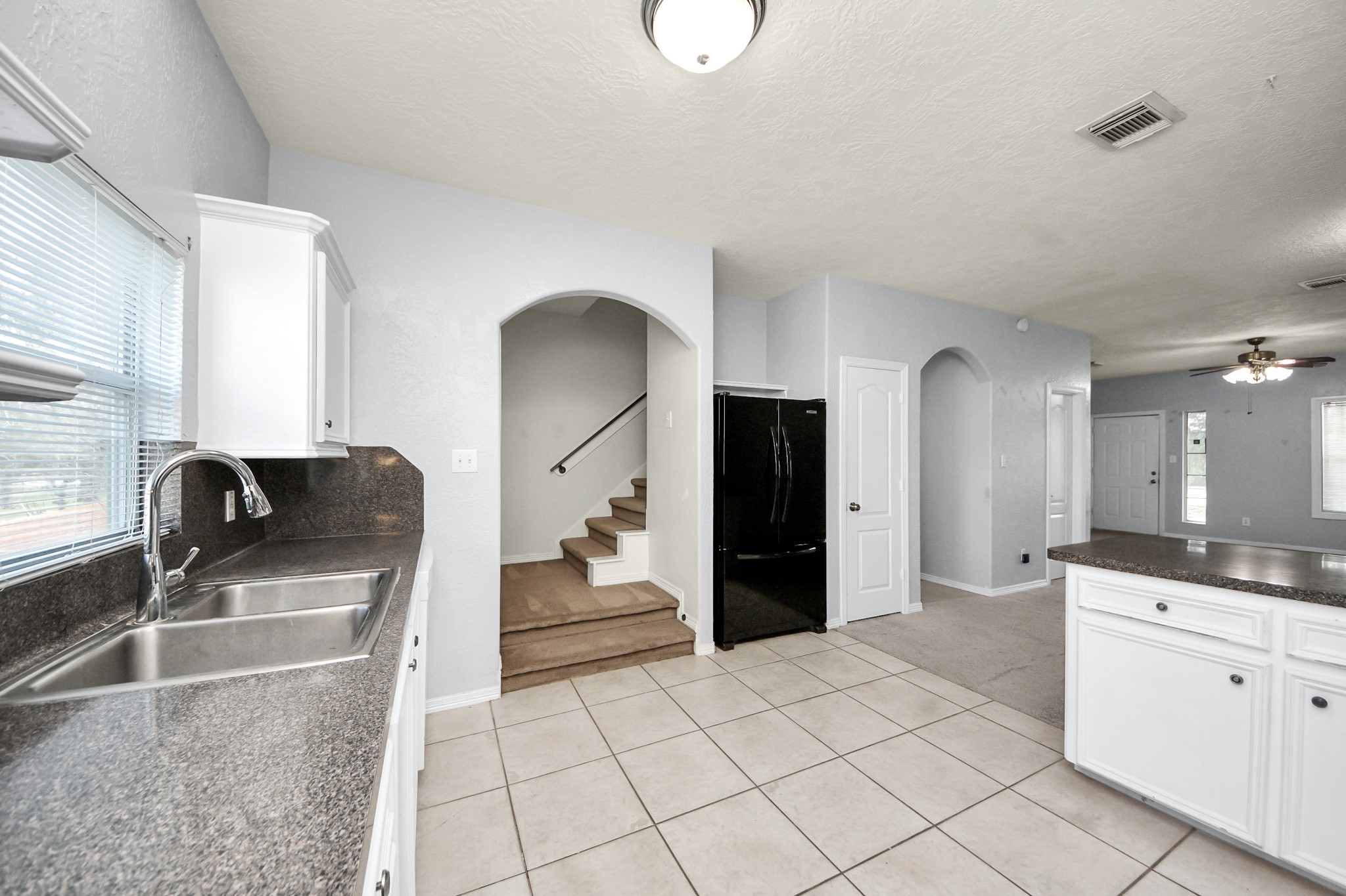 21940 Rayford Road, Unit B Humble, TX 77338 - Photo 11 of 38 a kitchen with stainless steel appliances granite countertop a sink and a refrigerator