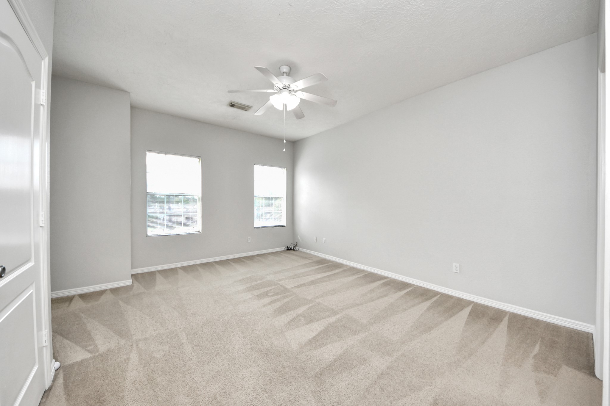 21940 Rayford Road, Unit B Humble, TX 77338 - Photo 17 of 38 an empty room with windows and fan