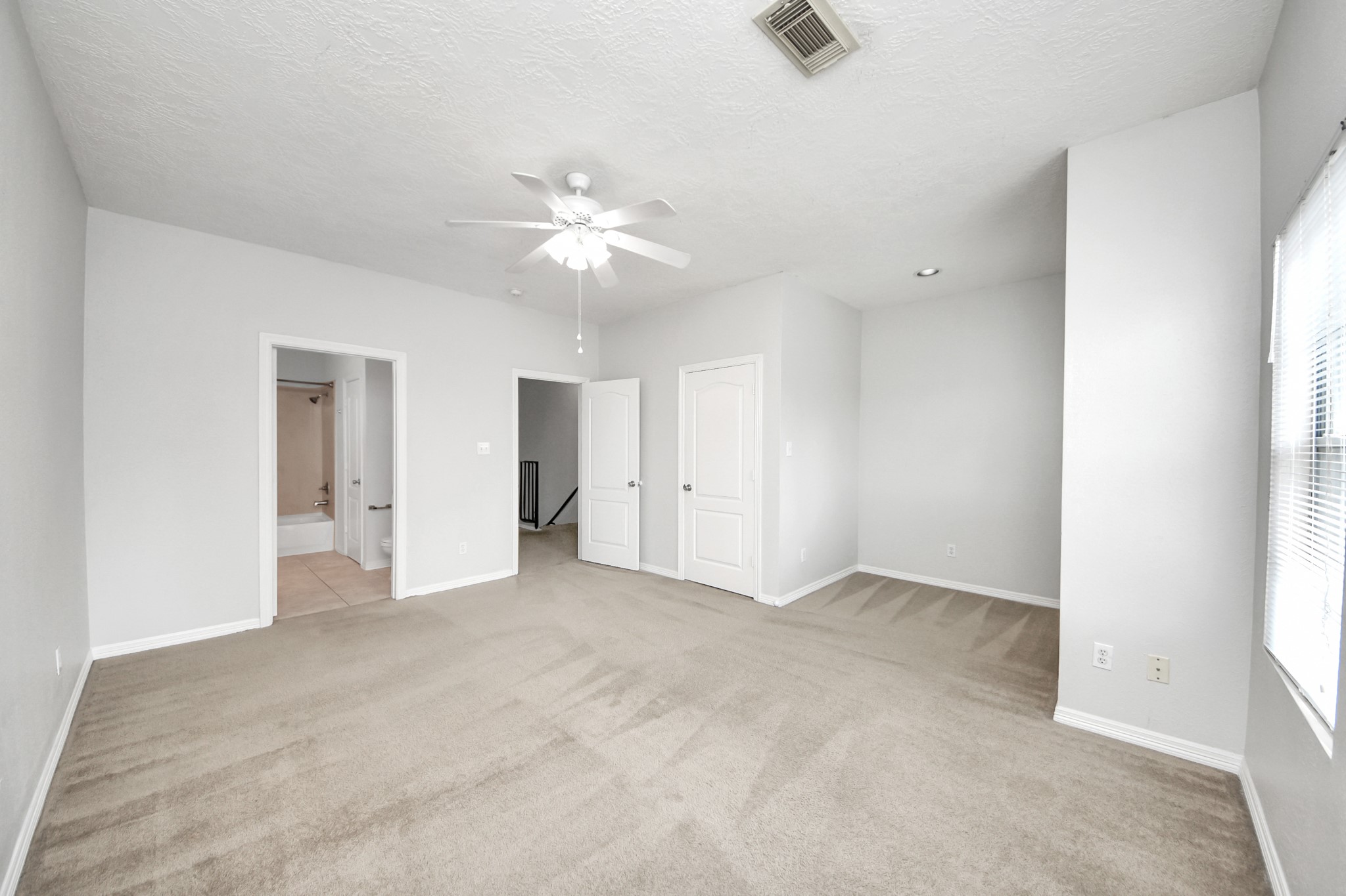 21940 Rayford Road, Unit B Humble, TX 77338 - Photo 18 of 38 an empty room with a ceiling fan and a window