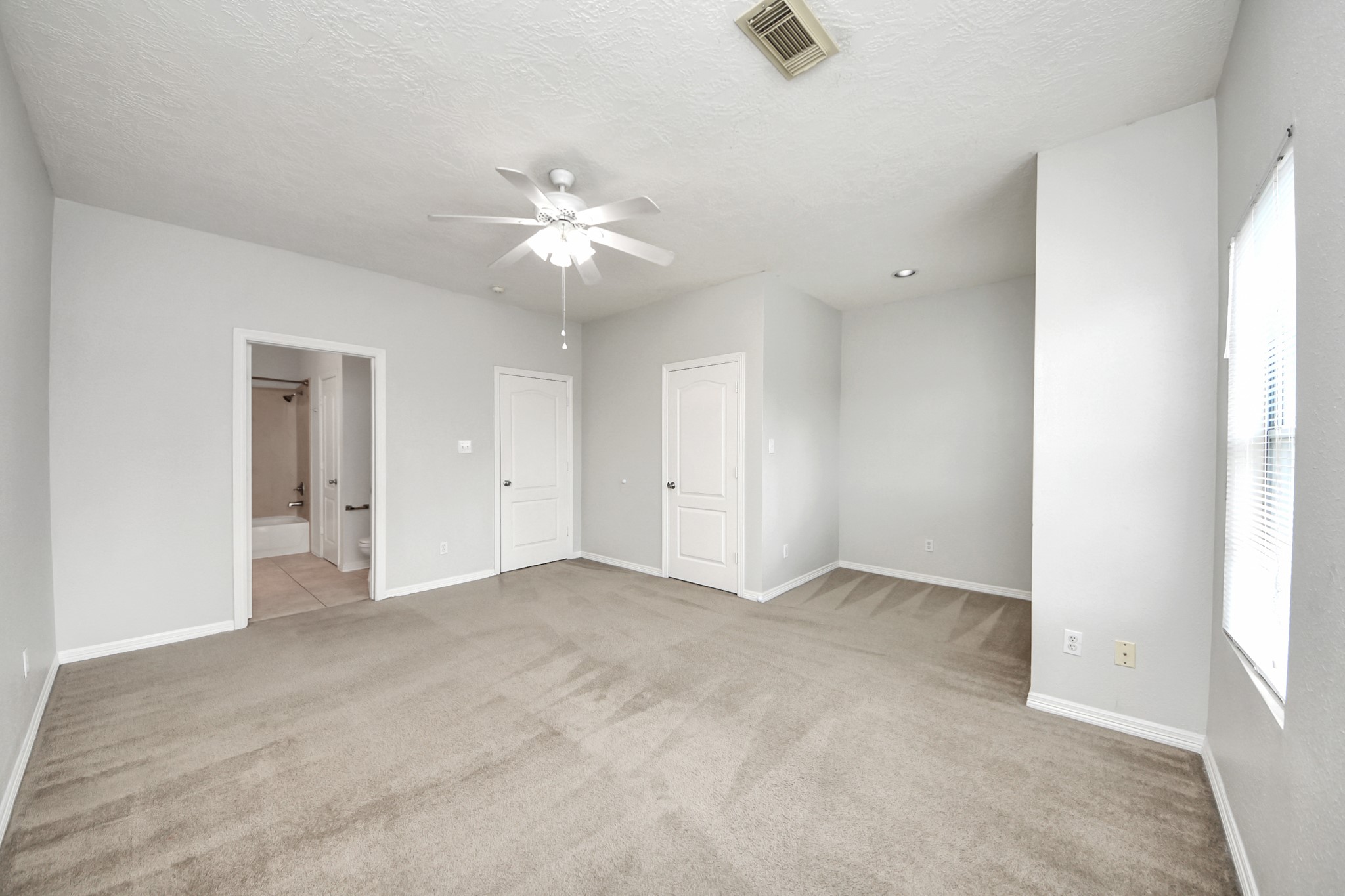 21940 Rayford Road, Unit B Humble, TX 77338 - Photo 19 of 38 an empty room with a ceiling fan and a window