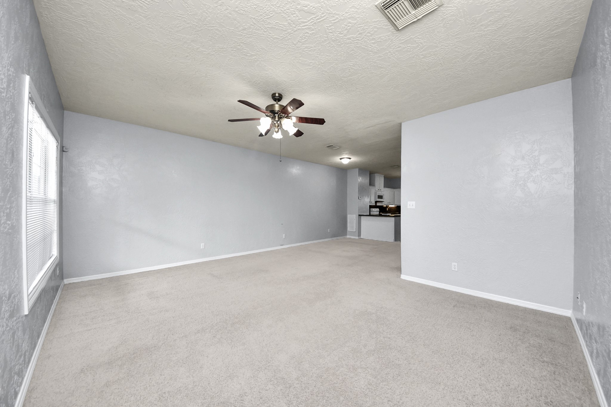 21940 Rayford Road, Unit B Humble, TX 77338 - Photo 2 of 38 an empty room with chandelier fan and windows