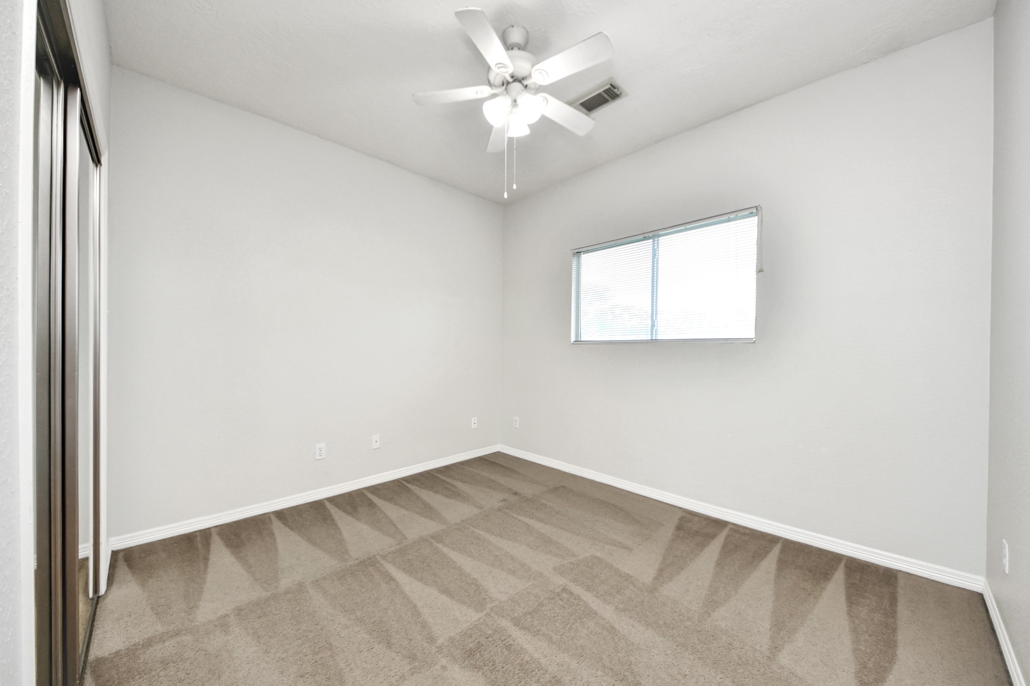 21940 Rayford Road, Unit B Humble, TX 77338 - Photo 23 of 38 an empty room with windows and fan