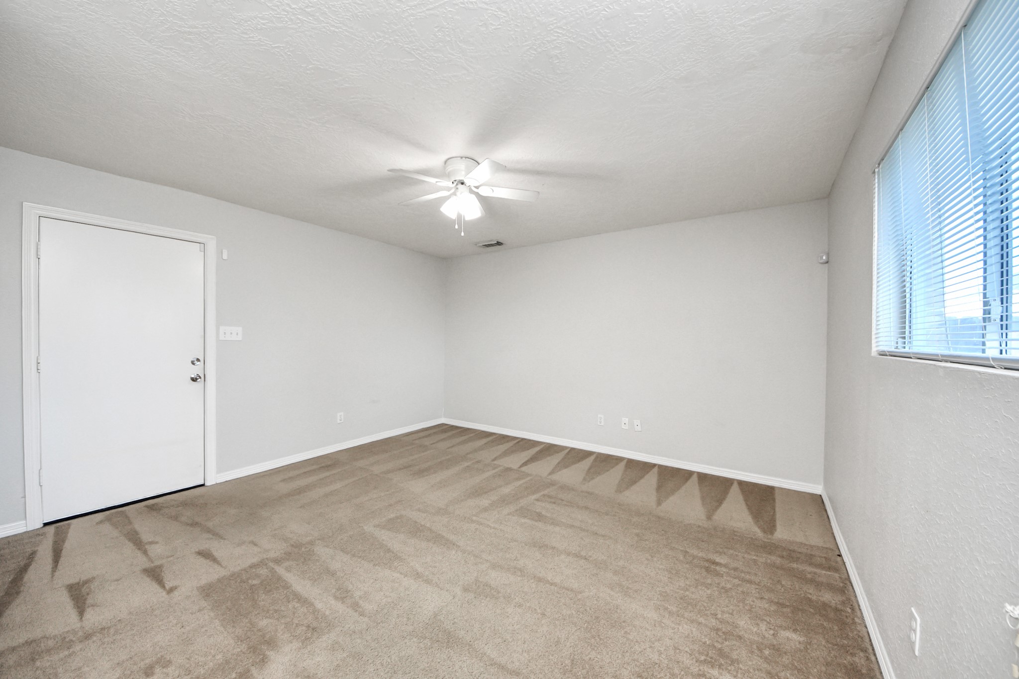 21940 Rayford Road, Unit B Humble, TX 77338 - Photo 30 of 38 an empty room with windows and fan