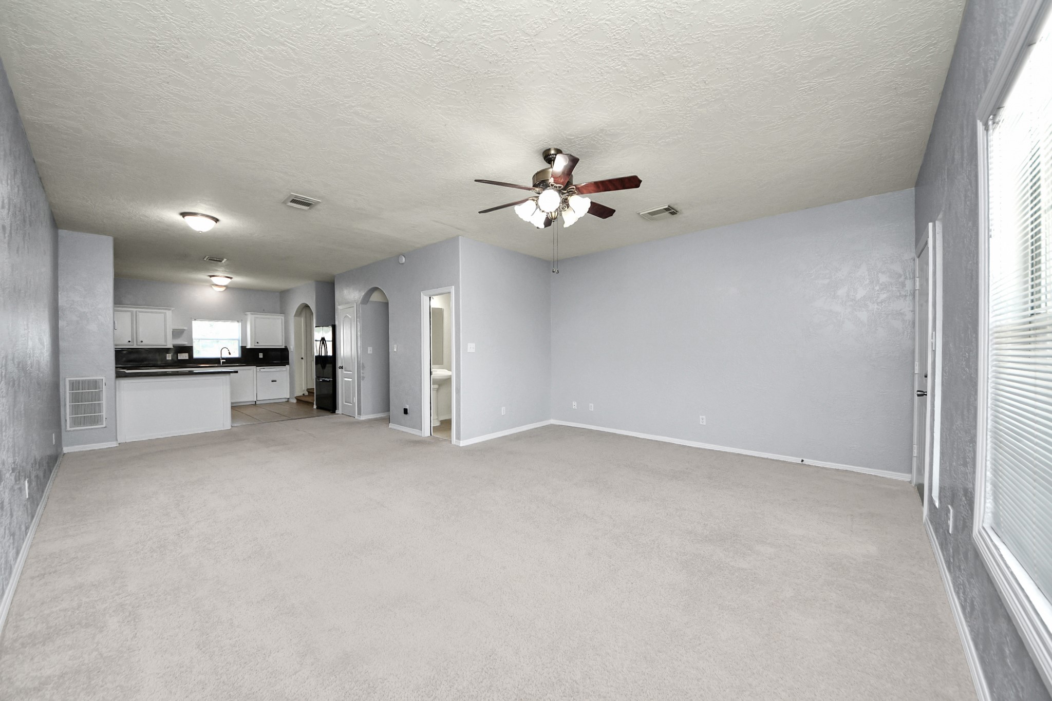 21940 Rayford Road, Unit B Humble, TX 77338 - Photo 3 of 38 a view of an empty room with a kitchen