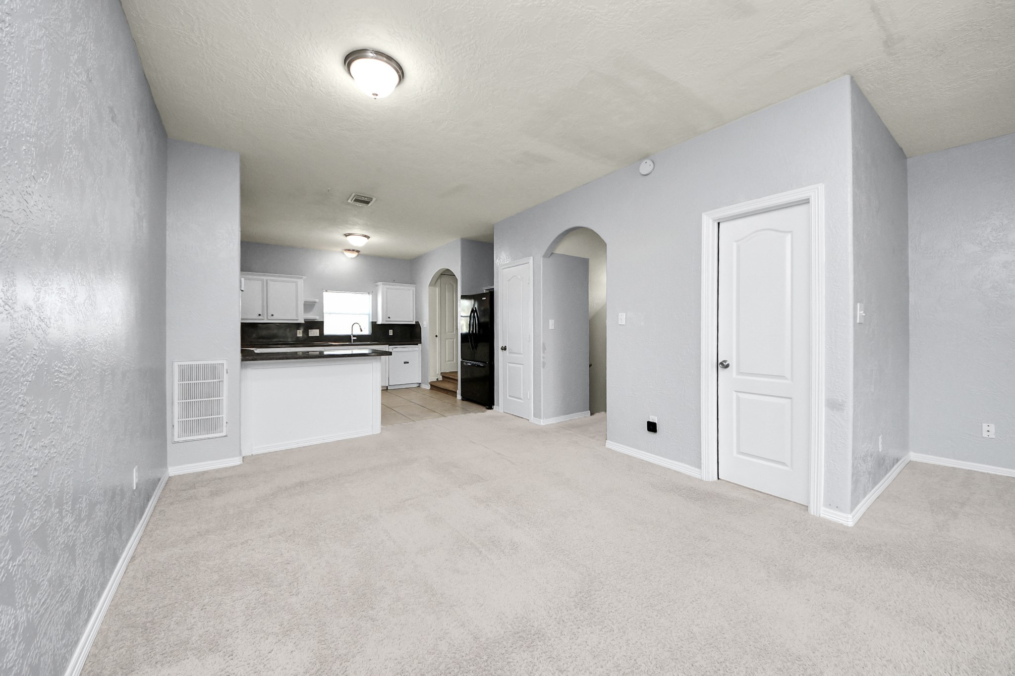 21940 Rayford Road, Unit B Humble, TX 77338 - Photo 5 of 38 a view of a kitchen with refrigerator and white cabinets